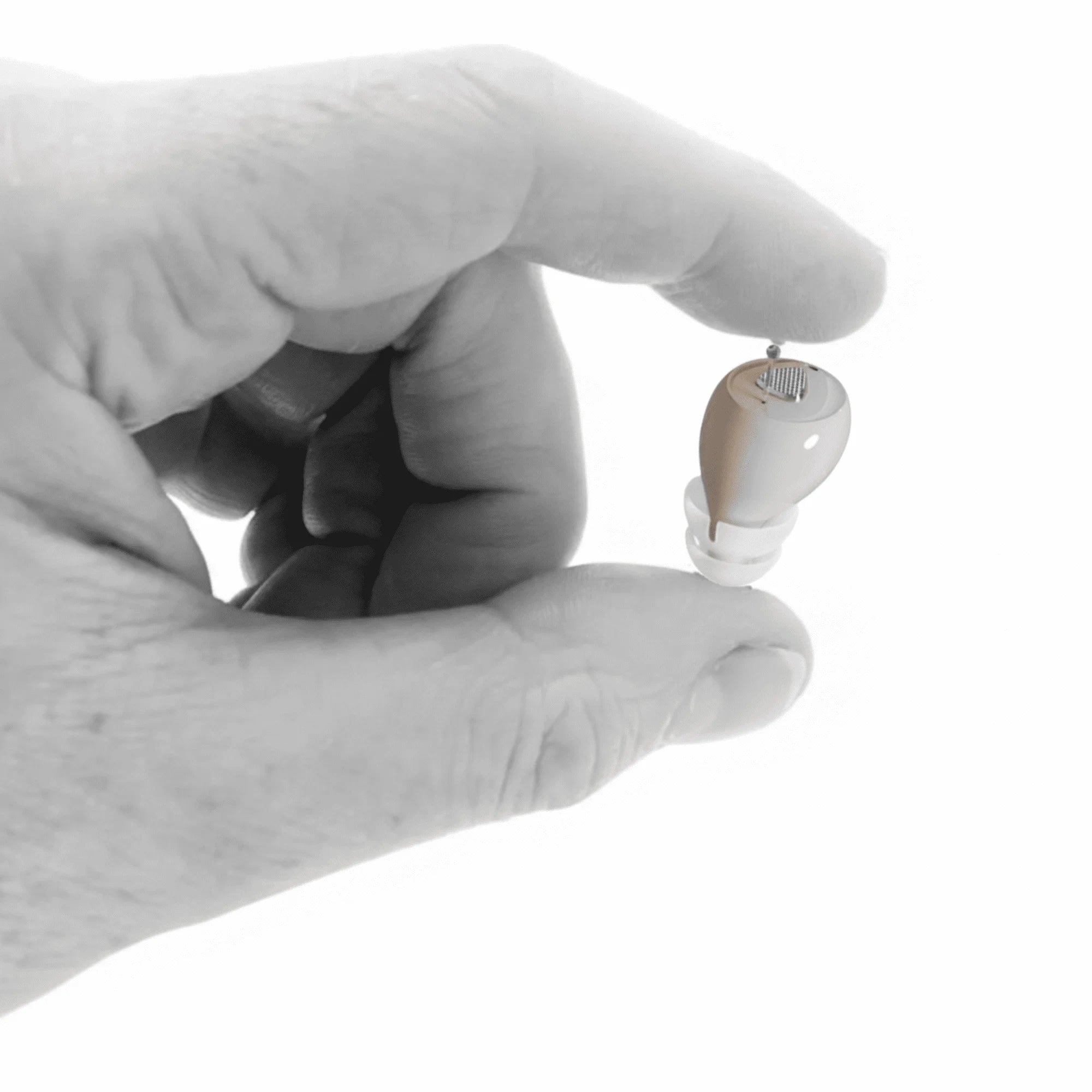 Panda Stealth nearly invisible in-canal hearing aid held on a fingertip