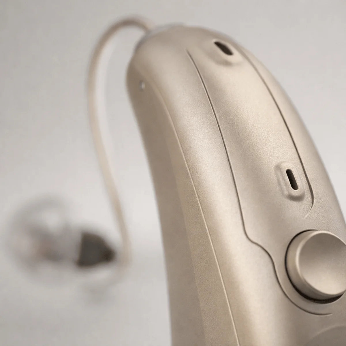 Man wearing Panda Quantum hearing aids while working at a desk, looking focused and comfortable